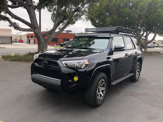 Black Toyota 4Runner from a distance with LED light bar and roof mounting brackets - Cali Raised LED